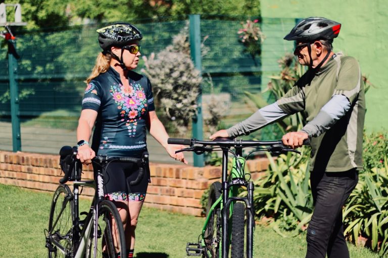 Alison Blair and Craig Vandeleur chatting beside their bicycles